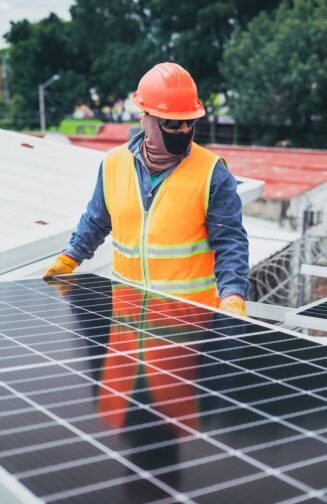 Maintenance Man Standing Beside a Solar Panel